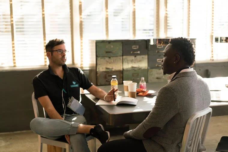a man sitting at a table with a guide