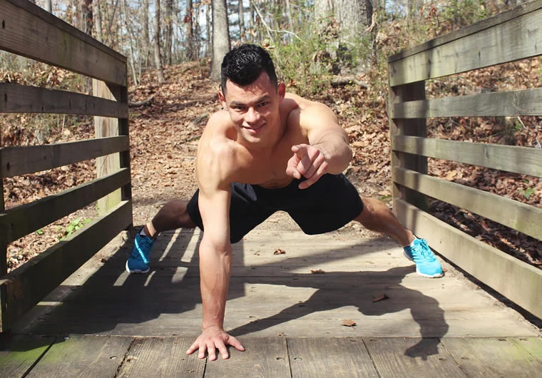a man doing push ups on a bridge
