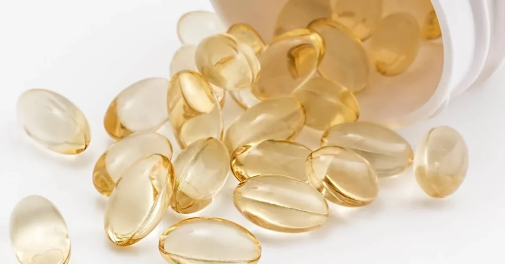 a group of yellow pills poring from a pill bottle