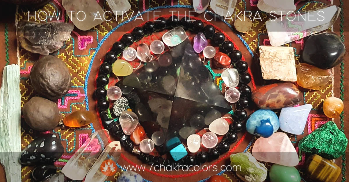 a group of chakra stones on a woven rug with shungite pyramid in the center