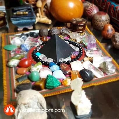 a stone pyramid and crystals on a table