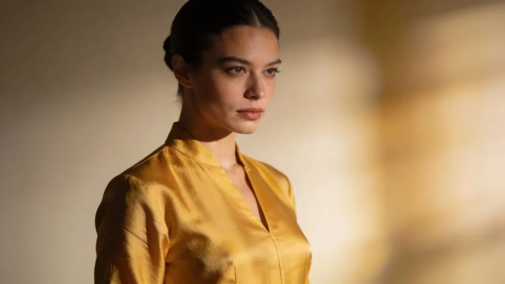 woman with confident posture wearing golden yellow clothes